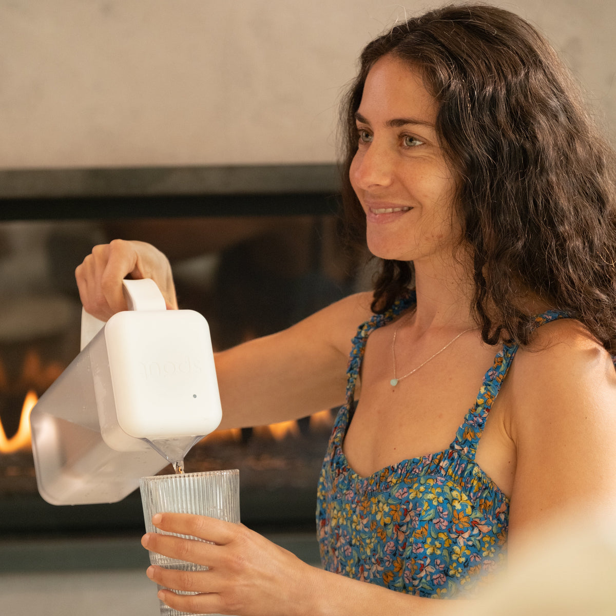 Pouring from the Always Fresh Pitcher by a fireplace